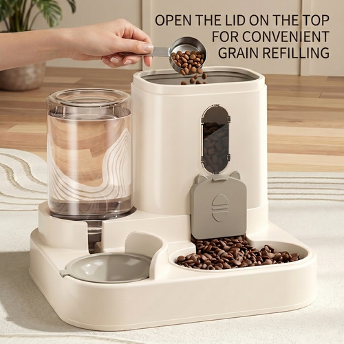 CozyPaws™ 2-in-1 automatic pet feeder grey — hand refilling dry food through top-fill lid with measuring scoop, gravity water bottle on left, cat-face dispensing gate visible, food kibble flowing into bowl