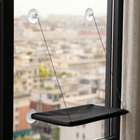 CozyPaws cat window hammock in black mounted on window with four suction cups and steel wire suspension showing city rooftop view - Image 6