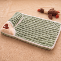 CozyPaws memory foam dog bed in green colour with cream sherpa trim and heart-shaped pillow, flat lay view with plush duck toy - Image 6