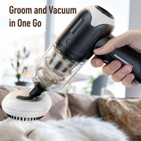 Close-up hand holding pet grooming vacuum with brush attachment collecting loose fur from white cat during brushing session - Image 4