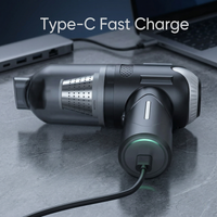 Pet grooming vacuum with Type-C fast charging cable plugged in showing green LED indicator light on dark floor - Image 6